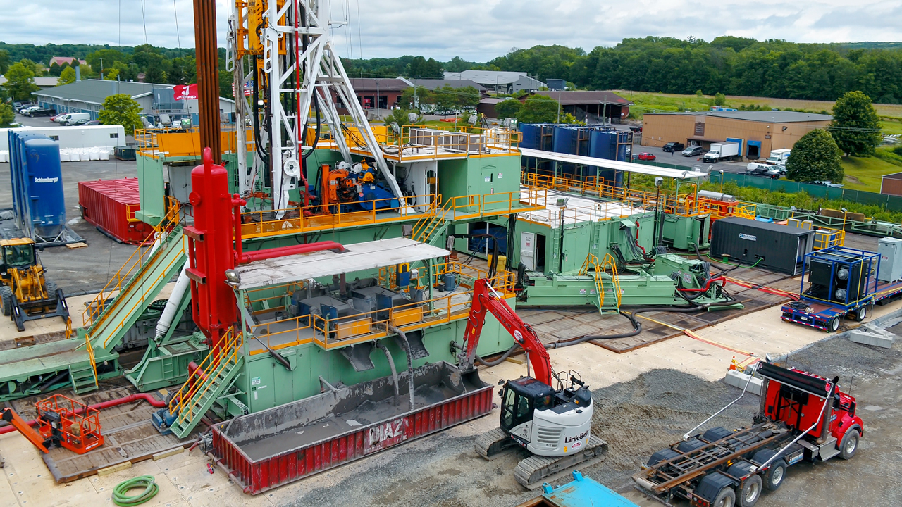 Shakers separate the rock chips (drill cuttings) from the drilling mud. The cuttings are then discharged into a container for disposal at a landfill (June 30, 2022).